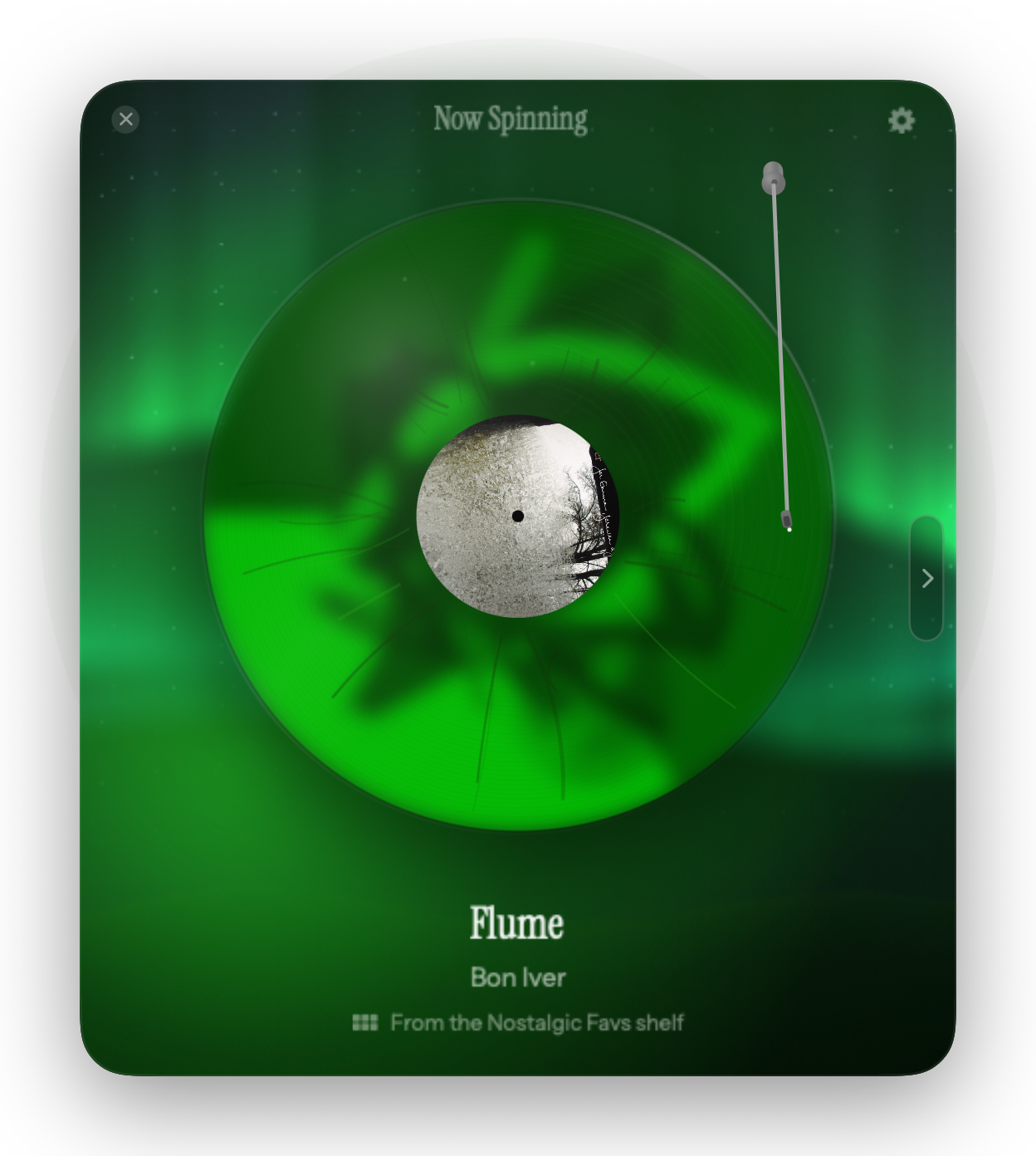 Aurora: curtains of light over a dark ridge, the room lit by the record